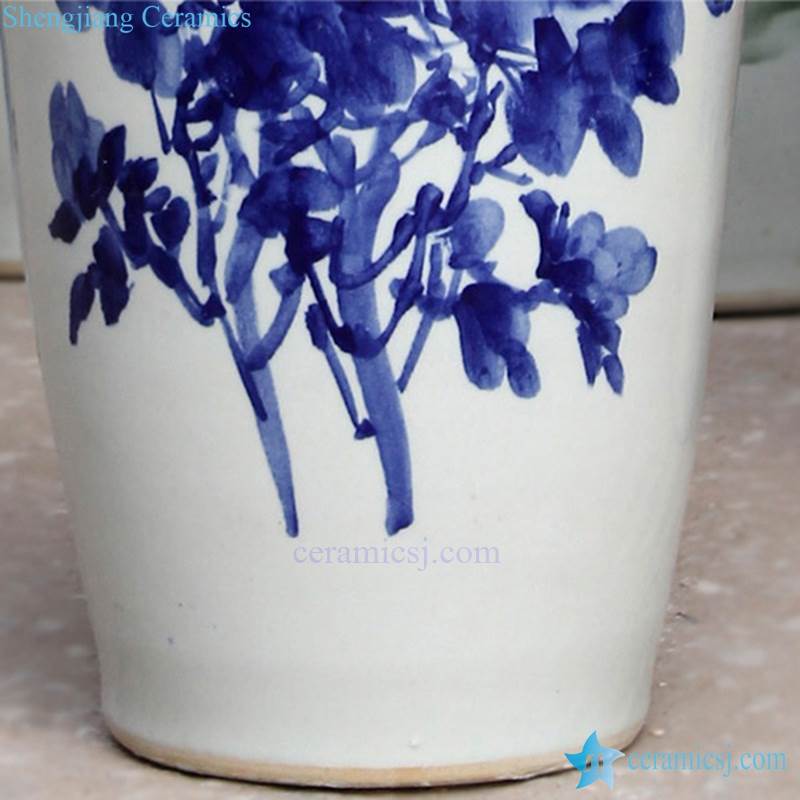 Tall blue and white ceramic vase with flower pattern 